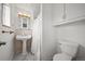 Cozy bathroom features pedestal sink, tiled walls, and a shower with a white curtain at 12024 W Maryland Dr, Lakewood, CO 80228