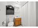 Bathroom with wood vanity, a toilet, and a shower with a white curtain at 12024 W Maryland Dr, Lakewood, CO 80228
