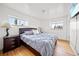 Cozy bedroom features hardwood floors, and two windows offering plenty of natural light at 12024 W Maryland Dr, Lakewood, CO 80228