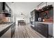 Bright kitchen featuring stainless steel appliances, brick backsplash, and an adjacent dining area at 12024 W Maryland Dr, Lakewood, CO 80228