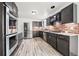 This kitchen offers stainless appliances, granite counters, ample cabinet space, and brick backsplash at 12024 W Maryland Dr, Lakewood, CO 80228