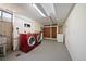Spacious laundry room featuring a utility sink, cabinets, closet, and modern red washer and dryer units at 12024 W Maryland Dr, Lakewood, CO 80228