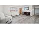 Bright living room featuring neutral walls, wood flooring, and modern furniture at 12024 W Maryland Dr, Lakewood, CO 80228
