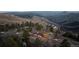 Aerial view of scenic mountainside community with cozy homes surrounded by lush trees at 18645 Rocky Top Trl, Littleton, CO 80127
