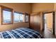 Bright bedroom featuring wood-trimmed windows and a large closet with wood door at 18645 Rocky Top Trl, Littleton, CO 80127