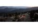 Scenic view of a cozy mountain home nestled among the trees at dusk at 18645 Rocky Top Trl, Littleton, CO 80127