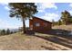 Charming home with a wood facade, a deck, and incredible mountain views from a hilltop perch at 18645 Rocky Top Trl, Littleton, CO 80127