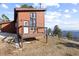Exterior view of a home with an elevated deck, ideal for enjoying the serene mountain setting at 18645 Rocky Top Trl, Littleton, CO 80127