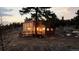 A wood cabin set among a forest with deck, stair access, and mountain views at 18645 Rocky Top Trl, Littleton, CO 80127