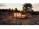 Charming cabin with wood siding and stair access nestled in a forest with scenic surroundings at 18645 Rocky Top Trl, Littleton, CO 80127