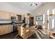 Well-lit kitchen with a center island, stainless steel appliances, and light wood cabinetry at 18645 Rocky Top Trl, Littleton, CO 80127