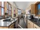 Modern kitchen featuring a central island, stainless steel appliances, and an open view to the living area at 18645 Rocky Top Trl, Littleton, CO 80127