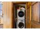 Laundry closet with stacked front load washer and dryer, and wood trimmed doorway at 18645 Rocky Top Trl, Littleton, CO 80127
