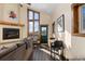 Inviting living room with fireplace, large windows offering picturesque views, and comfortable seating at 18645 Rocky Top Trl, Littleton, CO 80127