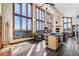 Bright living space features vaulted ceilings, hardwood floors, and oversized windows with scenic views at 18645 Rocky Top Trl, Littleton, CO 80127