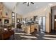 Open-concept kitchen and living area with hardwood floors, a fireplace, and expansive windows at 18645 Rocky Top Trl, Littleton, CO 80127
