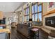 Bright living room with floor-to-ceiling windows, vaulted ceiling and wood burning fireplace at 18645 Rocky Top Trl, Littleton, CO 80127