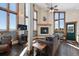 Cozy living room featuring a fireplace, large windows showcasing mountain views, and comfortable seating at 18645 Rocky Top Trl, Littleton, CO 80127