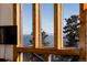 Breathtaking mountain view framed by large, multi-paned windows in the living area at 18645 Rocky Top Trl, Littleton, CO 80127
