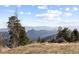 Expansive mountain view surrounded by trees and grass at 18645 Rocky Top Trl, Littleton, CO 80127