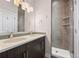 Modern bathroom with dual sinks, dark wood cabinets, vanity mirror, tile shower and overhead lighting at 2741 W 28Th Ave # 2, Denver, CO 80211