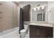 Bathroom featuring tile flooring, tub, shower with curtain, single sink vanity, and overhead lighting at 2741 W 28Th Ave # 2, Denver, CO 80211