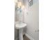 Powder room featuring a pedestal sink, modern fixtures, and elegant lighting at 2741 W 28Th Ave # 2, Denver, CO 80211