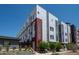 This modern condo building boasts gray and red trim and is surrounded by newly landscaped grounds at 2741 W 28Th Ave # 2, Denver, CO 80211