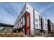 Modern townhouse featuring a striking white and grey facade with bold red accents and contemporary design at 2741 W 28Th Ave # 2, Denver, CO 80211