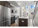 Modern kitchen featuring stainless steel appliances, wooden cabinets, and an island with bar seating at 2741 W 28Th Ave # 2, Denver, CO 80211
