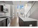Bright kitchen with stainless steel appliances, an island, and an open layout leading to a dining area at 2741 W 28Th Ave # 2, Denver, CO 80211