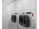 Laundry room with modern washer and dryer, plus overhead storage at 2741 W 28Th Ave # 2, Denver, CO 80211