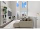 Bright living room featuring soaring ceilings, fireplace, large windows, and modern finishes at 2741 W 28Th Ave # 2, Denver, CO 80211