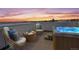 Inviting rooftop deck featuring comfortable seating, hot tub, and stunning city views at sunset at 2741 W 28Th Ave # 2, Denver, CO 80211