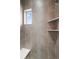 Walk-in tile shower with built-in shelves, bench, accent tile and window offering natural light at 2741 W 28Th Ave # 2, Denver, CO 80211