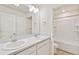 This bathroom features double sinks, a large mirror, and a tub with shower at 262 Chardon Ave, Brighton, CO 80601