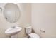 Elegant half bath with pedestal sink, brushed nickel fixtures, and modern lighting at 262 Chardon Ave, Brighton, CO 80601