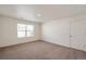 This bedroom features neutral carpet and a window providing natural light at 262 Chardon Ave, Brighton, CO 80601