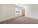 This bedroom features neutral carpet with an ensuite walk-in closet at 262 Chardon Ave, Brighton, CO 80601