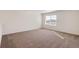 Comfortable bedroom with neutral carpet, white walls, and a bright window at 262 Chardon Ave, Brighton, CO 80601