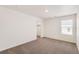 This bedroom features neutral carpet and a window that brings in natural light at 262 Chardon Ave, Brighton, CO 80601