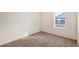 This carpeted bedroom has bright natural light from a large window at 262 Chardon Ave, Brighton, CO 80601