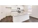Well-equipped kitchen with white cabinets, granite countertops, and a large center island at 262 Chardon Ave, Brighton, CO 80601