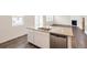 Kitchen island featuring a double sink, stainless dishwasher and granite countertops at 262 Chardon Ave, Brighton, CO 80601