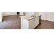 Kitchen island featuring a double sink, stainless dishwasher and granite countertops, and kitchen views at 262 Chardon Ave, Brighton, CO 80601