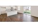 Bright kitchen with stainless appliances, granite countertops, and sliding glass door to backyard at 262 Chardon Ave, Brighton, CO 80601