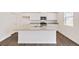 Beautiful kitchen featuring white cabinetry, granite countertops, and modern appliances at 262 Chardon Ave, Brighton, CO 80601