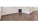 Spacious living room featuring a cozy fireplace and warm, wood-look flooring at 262 Chardon Ave, Brighton, CO 80601