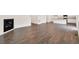 Open-concept living space with hardwood floors, fireplace, kitchen with island, and plentiful natural light at 262 Chardon Ave, Brighton, CO 80601
