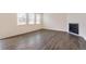 Inviting living room boasting hardwood floors, a modern fireplace, and plenty of natural light from large windows at 262 Chardon Ave, Brighton, CO 80601